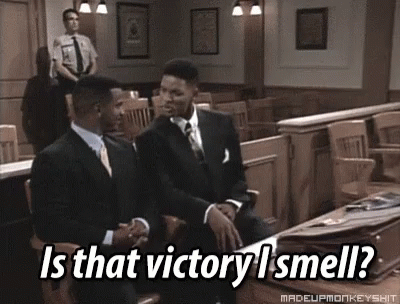 Two Men In Suits Are Sitting In A Courtroom With The Caption Is That Victory I Smell ? GIF