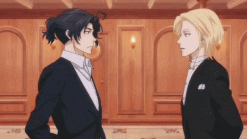 Two Men In Suits Are Standing Next To Each Other And Looking At Each Other . GIF