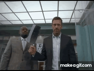 Two Men In Suits Are Standing Next To Each Other Holding A Large X-Ray . GIF
