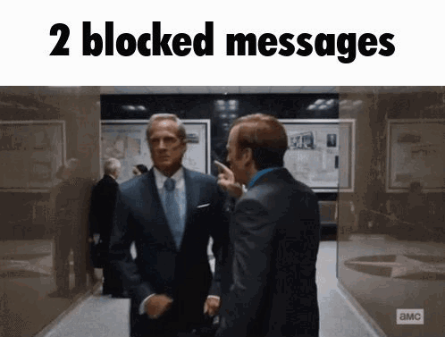 Two Men In Suits Are Standing Next To Each Other In A Hallway With The Words " 2 Blocked Messages " Above Them . GIF