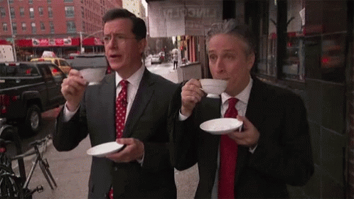 Two Men in Suits Drinking Coffee
