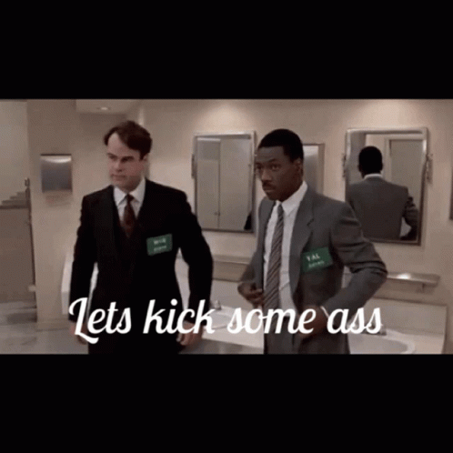 Two Men in Suits in Bathroom Saying Lets Kick Some Ass