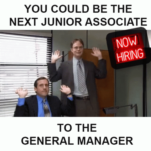 Two Men in Suits in Front of Now Hiring Sign