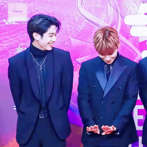 Two Men In Suits On Purple Carpet GIF