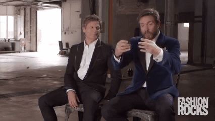 Two Men in Suits Sitting With Fashion Rocks