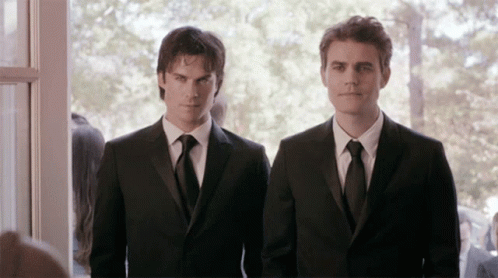 two men in suits standing next to each other