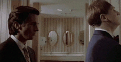 Two Men In Suits Standing Together GIF