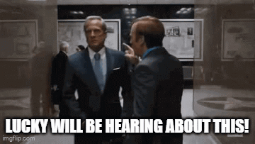 Two Men In Suits Talking In Hallway Lucky Will Be Hearing About This GIF