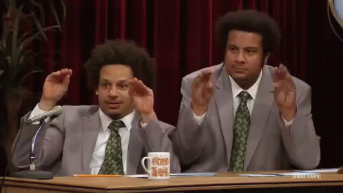 Two Men In Suits With Microphone And Mug GIF