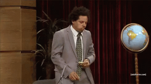 Two Men In Suits With Microphone And Mug GIF