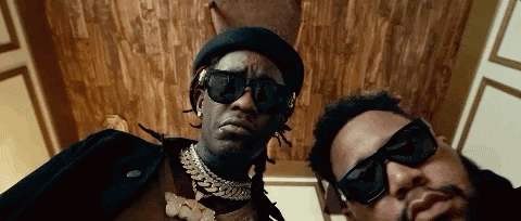 Two Men In Sunglasses And Hats Posing GIF