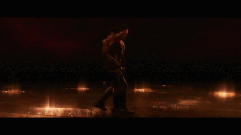 Two Men In Superhero Costumes Standing In Dark GIF