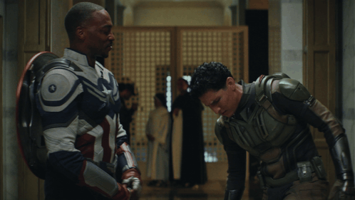 Two Men in Superhero Costumes Standing Together