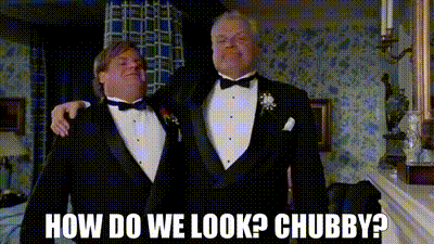 Two Men In Tuxedos Are Standing Next To Each Other And One Of Them Is Asking How Do We Look ? Chubby ? GIF