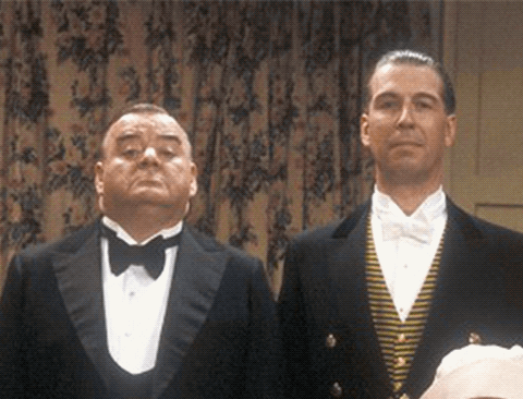 Two Men In Tuxedos Stand Next To Each Other GIF