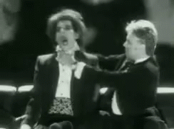 Two Men In Tuxedos Talking GIF