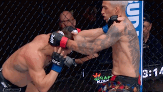 Two Men In Ufc Gloves Are Fighting In A Boxing Ring GIF