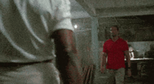 Two Men In White And Red Shirts Standing Together GIF