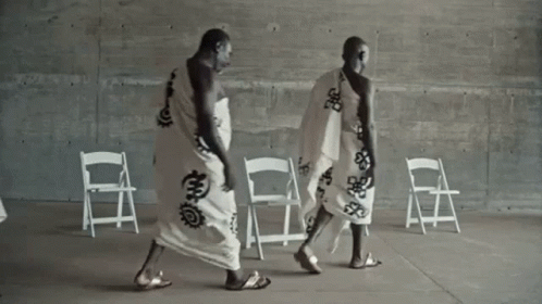 Two Men in White Robes Walking
