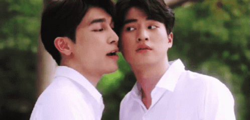 Two Men in White Shirts Kissing on Cheeks