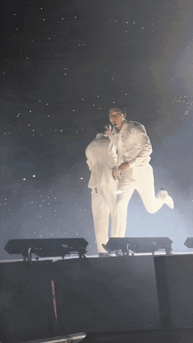 Two Men in White Suits Holding