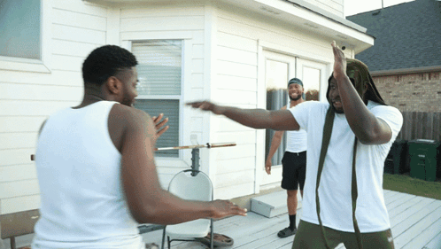 Two Men In White Tank Tops On Deck GIF