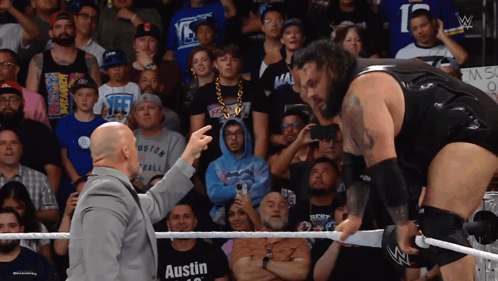 Two Men in Wrestling Ring One Wearing Austin T-Shirt