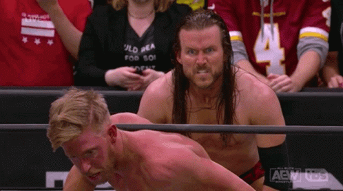 Two Men in Wrestling Ring With AEW Logo