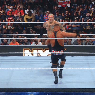 Two Men In Wrestling Ring With NY Sign GIF