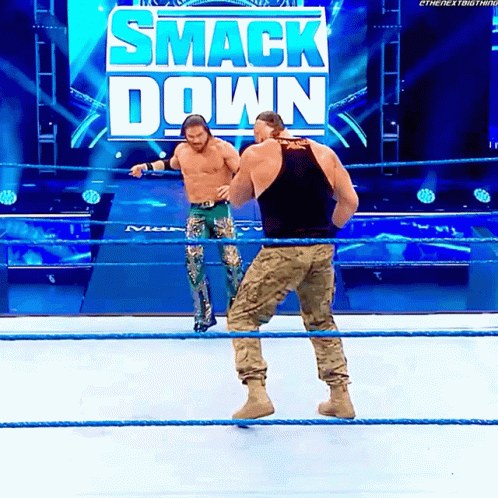 Two Men In Wrestling Ring With Smack Down Sign GIF
