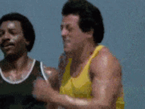 Two Men in Yellow and Black Tank Tops Running