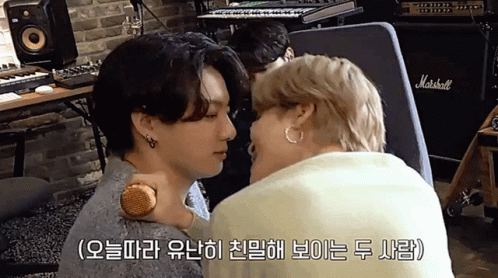Two Men Kissing in Front of Marshall Amplifier
