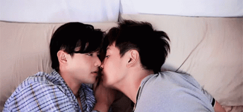 Two Men Kissing On Bed GIF