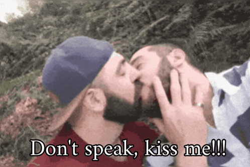 Two Men Kissing With The Words " Do N't Speak Kiss Me " Written Below Them GIF