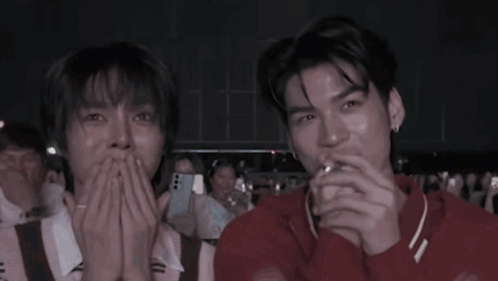 Two Men Laughing in Crowd