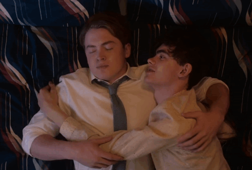 Two Men Laying On A Bed With A Caption That Says Hmm No GIF