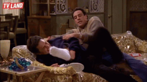 Two Men Laying On A Couch With Tv Land Written On The Bottom Left GIF