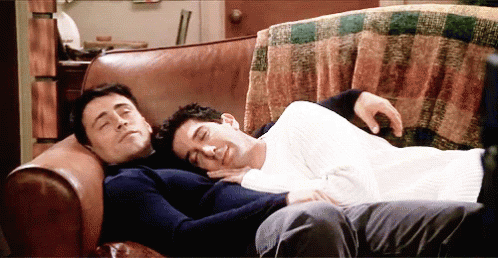 Two Men Laying On Couch Heads Together GIF