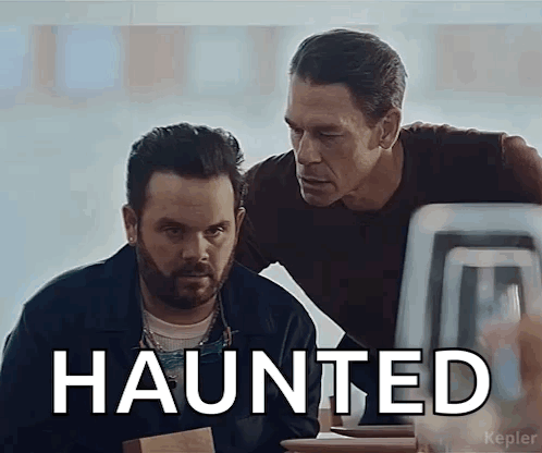 Two Men Looking at Computer Screen Saying Haunted