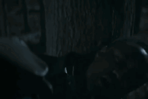 Two Men Looking at Each Other in Dark Room