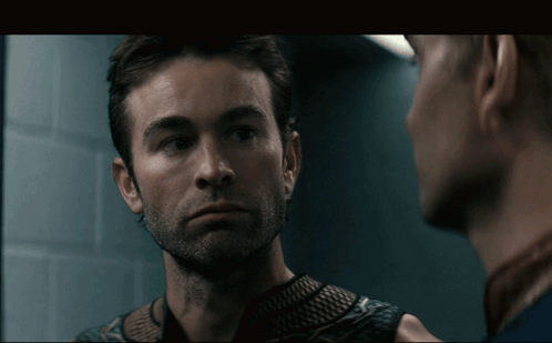 Two Men Looking At Each Other In Mirror GIF