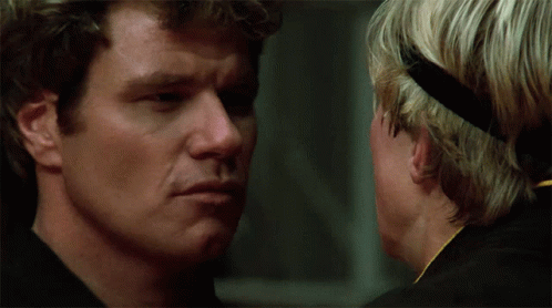 Two Men Looking At Each Other One With Headband GIF