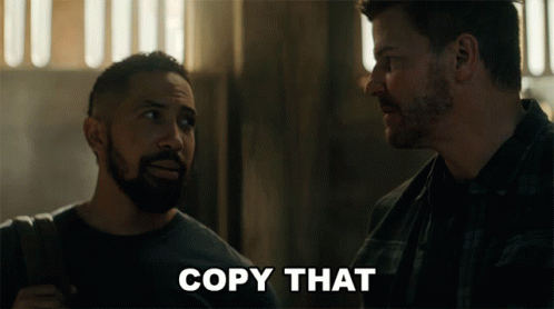 Two Men Looking at Each Other Saying Copy That