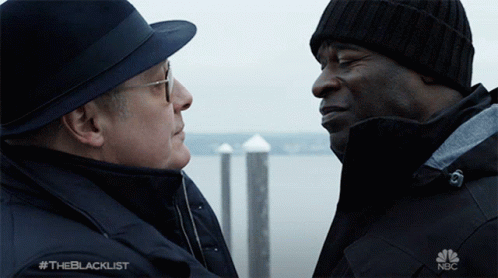 Two Men Looking at Each Other With NBC Logo