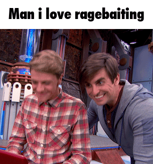 Two Men Looking at Laptop Ragebaiting