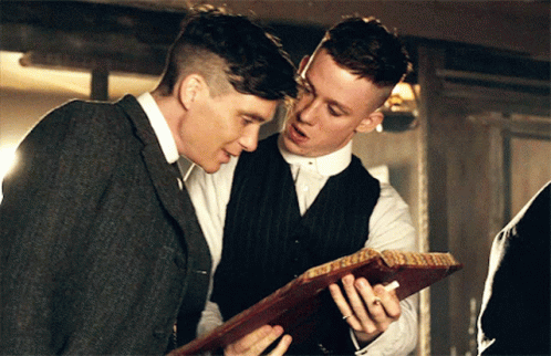 Two Men Looking At Paper Together GIF