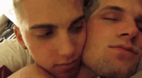 Two Men Lying on Bed Kissing