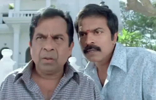 Two Men Making Funny Faces in Front of Building