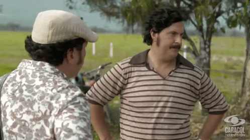 Two Men Next To Caracol Television GIF