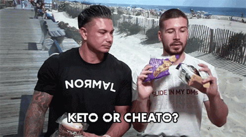 Two Men on Boardwalk One with Keto or Cheato Shirt